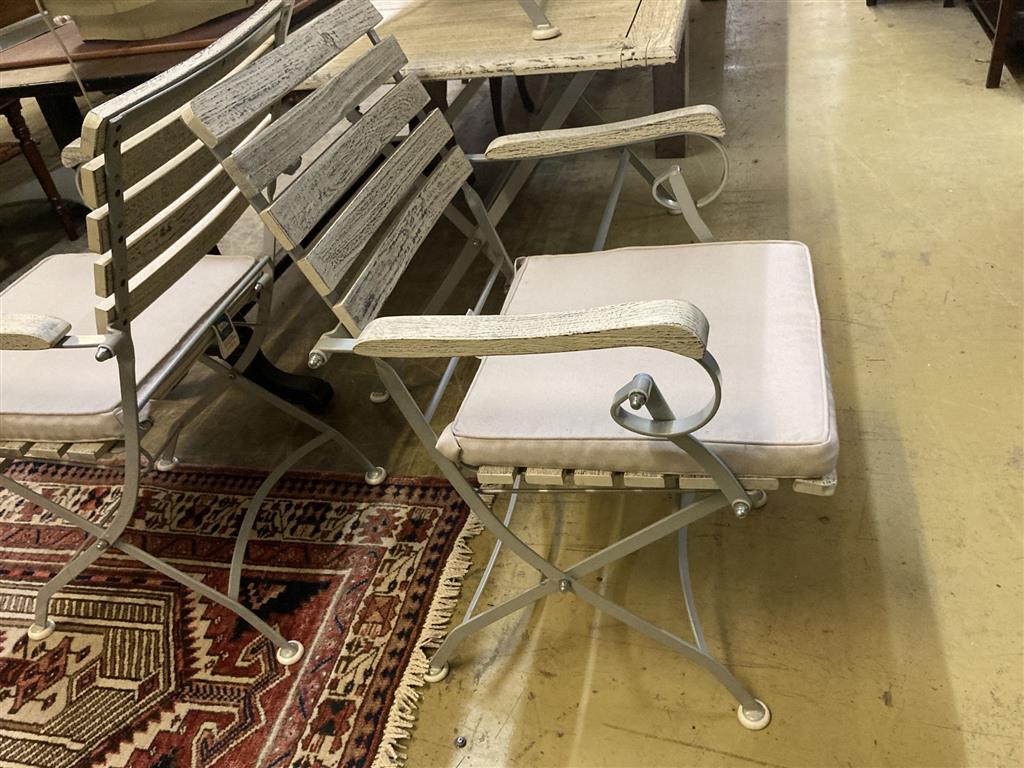 A modern painted slatted wood and metal garden suite of folding table, width 120cm, depth 72cm, height 75cm, bench and a pair of elbow